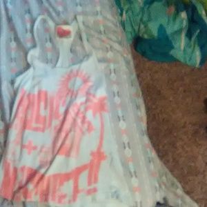 A tank top that is light white blur and neon orang